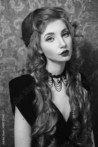 Portrait Of A Woman With Long Red Curly Hair In A Black And Red