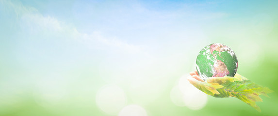 World environment day concept: Double exposure hands of tree and earth global on blurred nature background. Elements of this image furnished by NASA