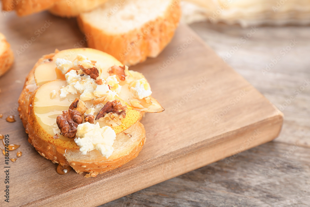 Woman preparing delicious bruschettas on table