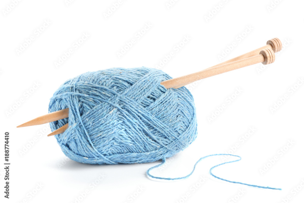 Thread and knitting needles on white background