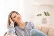 © Africa Studio - Young smiling woman resting in armchair indoors