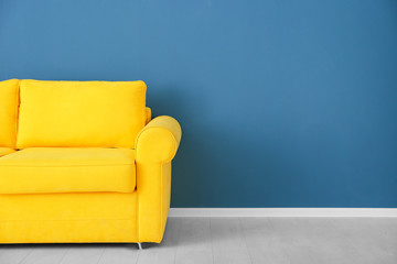 Wall Mural - Bright yellow couch near color wall