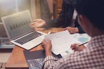 Business people presentaion with tablet screen finance and paper charts finance at the table in room meeting at the office