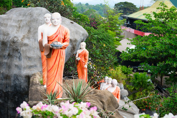 Wall Mural - Statues of monks in Golden cave temple in Dambulla, Sri Lanka