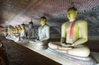 Group of sitting Buddha statues in cave buddhist temple