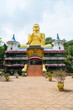 Big golden Buddha statue in wheel-turning pose in Dambulla Golden temple