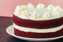 Red Velvet Cake With Cream Cheese Frosting On A White Plate