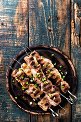 Wall Mural - Grilled meat skewers, shish kebab on wooden background, top view