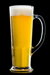 Wall Mural - A glass of frosty fresh light unfiltered beer on dark background