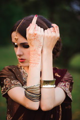 Portrait smiling of beautiful indian girl. Young indian woman model with red jewelry set .