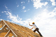 Leinwandbild Motiv roofer carpenter working on roof structure on building site