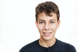 © Мар'ян Філь - A nice boy with braces on his teeth smiles on a white background. He is dressed in a dark shirt
