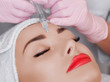 © Dimid - The doctor cosmetologist makes the Rejuvenating facial injections procedure for tightening and smoothing wrinkles on the face skin of a beautiful, young woman in a beauty salon.Cosmetology skin care.