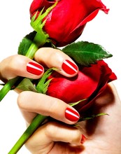 Women With Red Fingernails Holding Two Red Roses