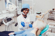 © andrey_orlov - young black girl doctor dentist treats white girl's teeth