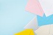 © juliasudnitskaya - Border from colorful envelopes on blue table top view. Mockup for business mail, blogging and office correspondence. Flat lay.