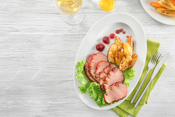 Poster - Plate with sliced honey baked ham and potato on wooden table