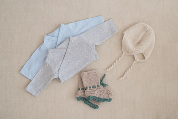 newborn baby clothes - studio shot from above
isolated little silk body on natural woolen background