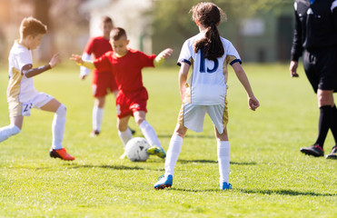 Wall Mural - Young children players football match on soccer field