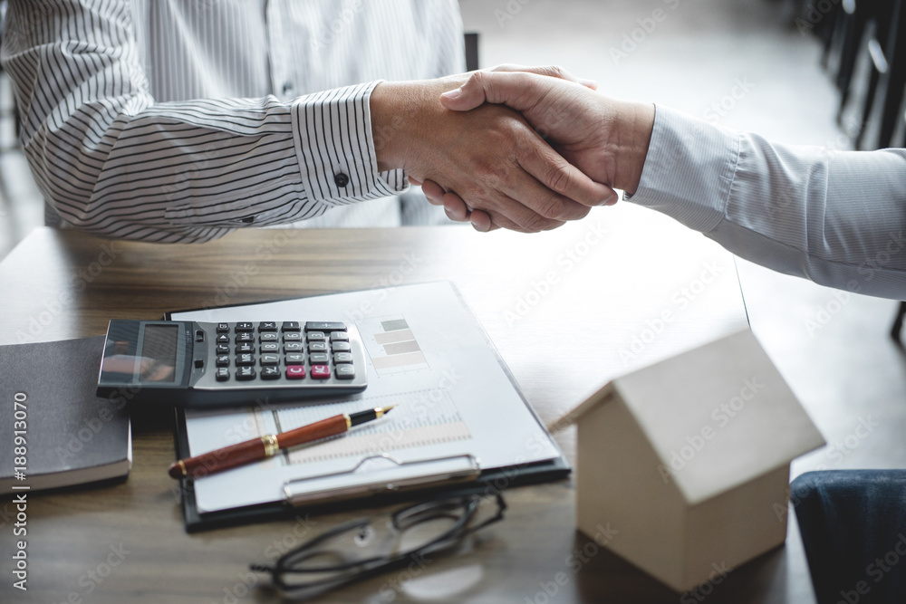 Real estate broker agent and customer shaking hands after signing contract documents for realty purchase, Bank employees congratulate, Concept mortgage loan approval - obrazy, fototapety, plakaty 