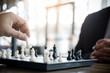 © Freedomz - Confident businessman colleagues playing chess game overcome the fear of confrontation to development analysis new strategy plan, leader and teamwork concept for success