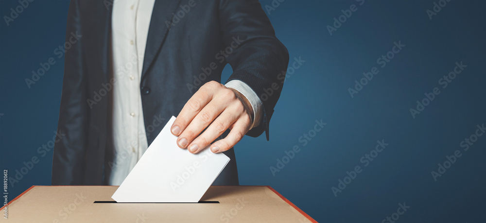 Man Voter Putting Ballot Into Voting box. Democracy Freedom Concept On Blue Background With Copy-Space - obrazy, fototapety, plakaty 