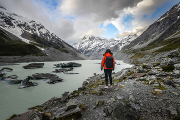 woman backpacker standing on the destination point at mt cook in new zealand