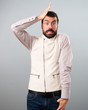© luismolinero - Handsome man with vest having doubts on grey background