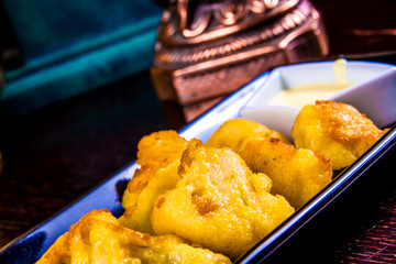 Wall Mural - Deep Fried cauliflower with sauce on black plate