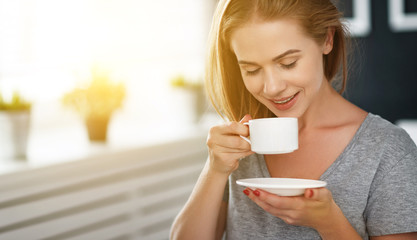 Poster - happy young woman with cup of morning coffee in bed