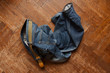 © macondos - blue jeans thrown on wooden floor
