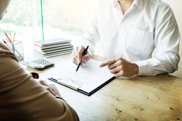 Wall Mural - Young business team working with new startup project offering contract paper to his business partner for sign contract in conference room. discussing. Business accounting financial meeting concept