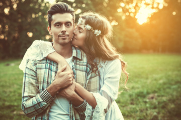 Wall Mural - Young lovely couple at sunset