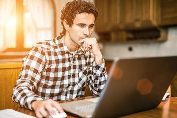 Man using his laptop computer at home