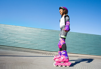 Wall Mural - African girl practicing at outdoor rollerdrom