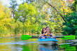 © Iuliia Sokolovska - Family kayaking sport, mother and child paddling in kayak on river canoe tour, active autumn weekend and vacation, fitness concept