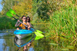 © Iuliia Sokolovska - Family kayaking sport, mother and child paddling in kayak on river canoe tour, active autumn weekend and vacation, fitness concept