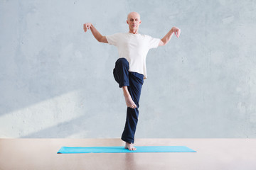 man praticing tai chi chuan in the gym. Chinese management skill Qi's energy. WU-SHU.