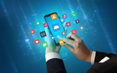 Hand using smartphone with application icons
