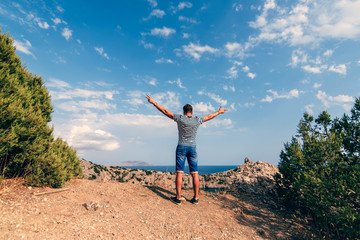 Wall Mural - male traveler with arms raised to the sky