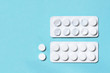 Full and used white blister pills on a blue background. Medications