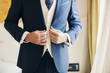 © RooM The Agency - Close-up front mid section view of a man wearing a smart suit with a waistcoat