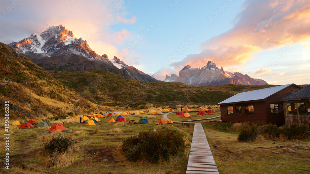 Colorful tent camping early morning with sunrise in Torres del Paine National Park, Patagonia mountains, Chile - obrazy, fototapety, plakaty 