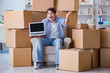 © Elnur - Young man moving in to new house with boxes