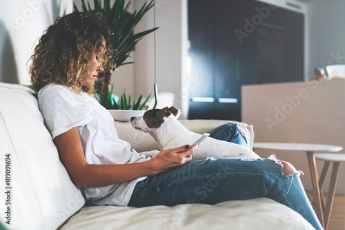Young Blonde Girl Resting While Sitting With Her Dog On The