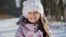 Little Girl Ten Years Blowing Snow. Slow Motion