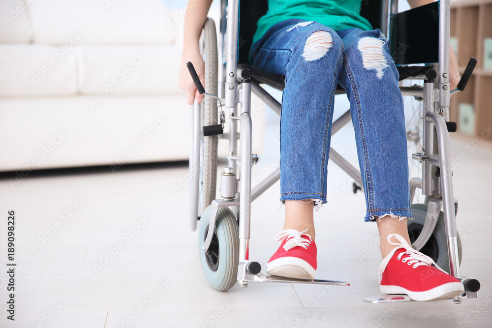 Girl in wheelchair indoors
