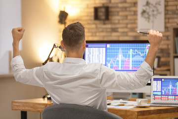 Canvas Print - Young stock exchange trader working in office