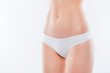 © deagreez - Guts hairless smooth fresh pure flawless soft after shaving treatment skinny indigestion trouble maternity concept. Cropped close up photo of thin slender woman's hips isolated on background