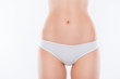 © deagreez - Reproduction system early maternity intimate zone waxing laser concept. Cropped close up photo of thin skinny woman's skinny hips dressed in white classic underclothes isolated on background